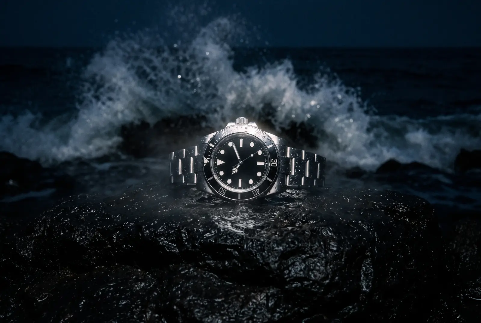 Wristwatch on wet black rock as a wave breaks behind, a campaign frame made from a phone photo