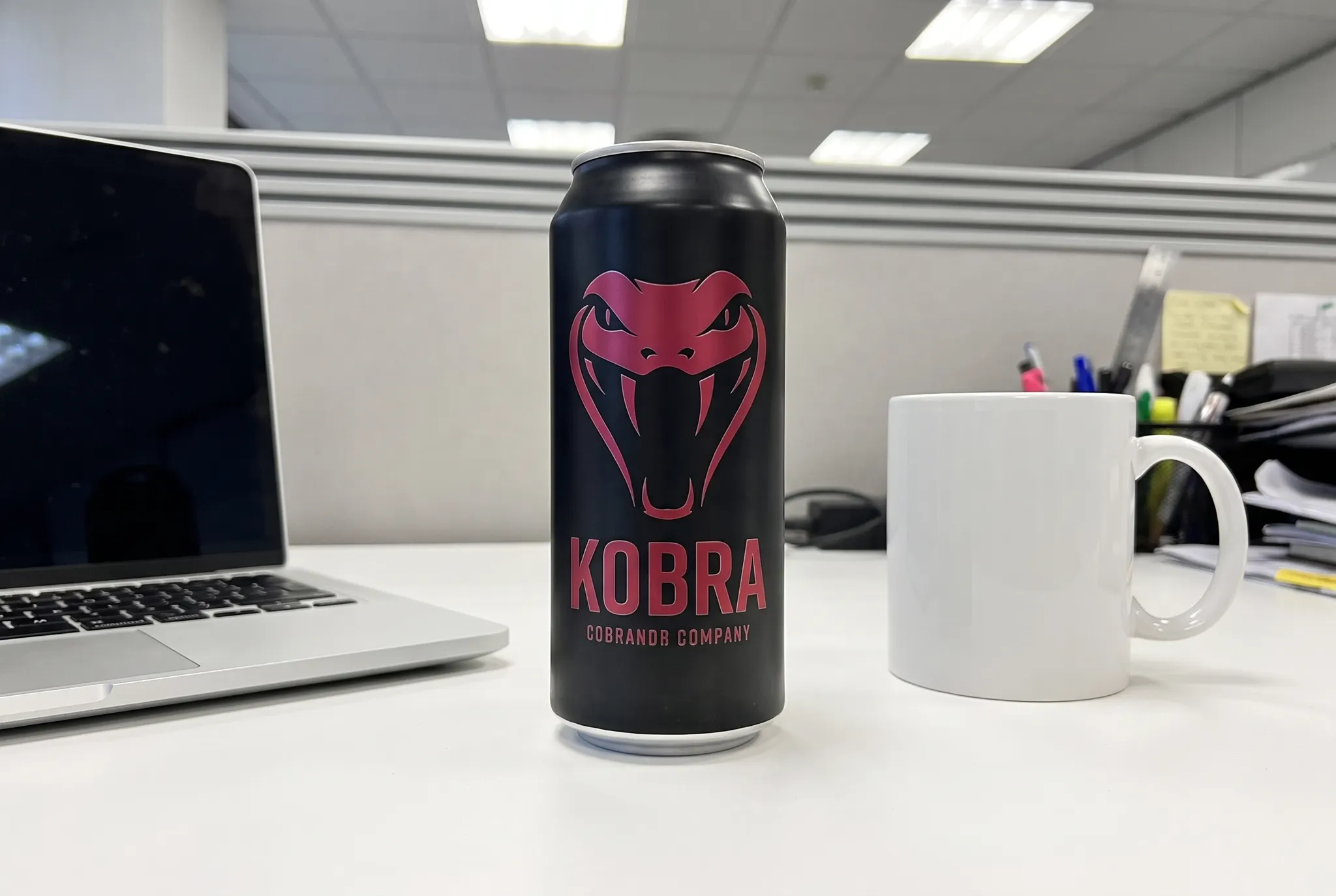 Energy drink can on an office desk, shot on a phone