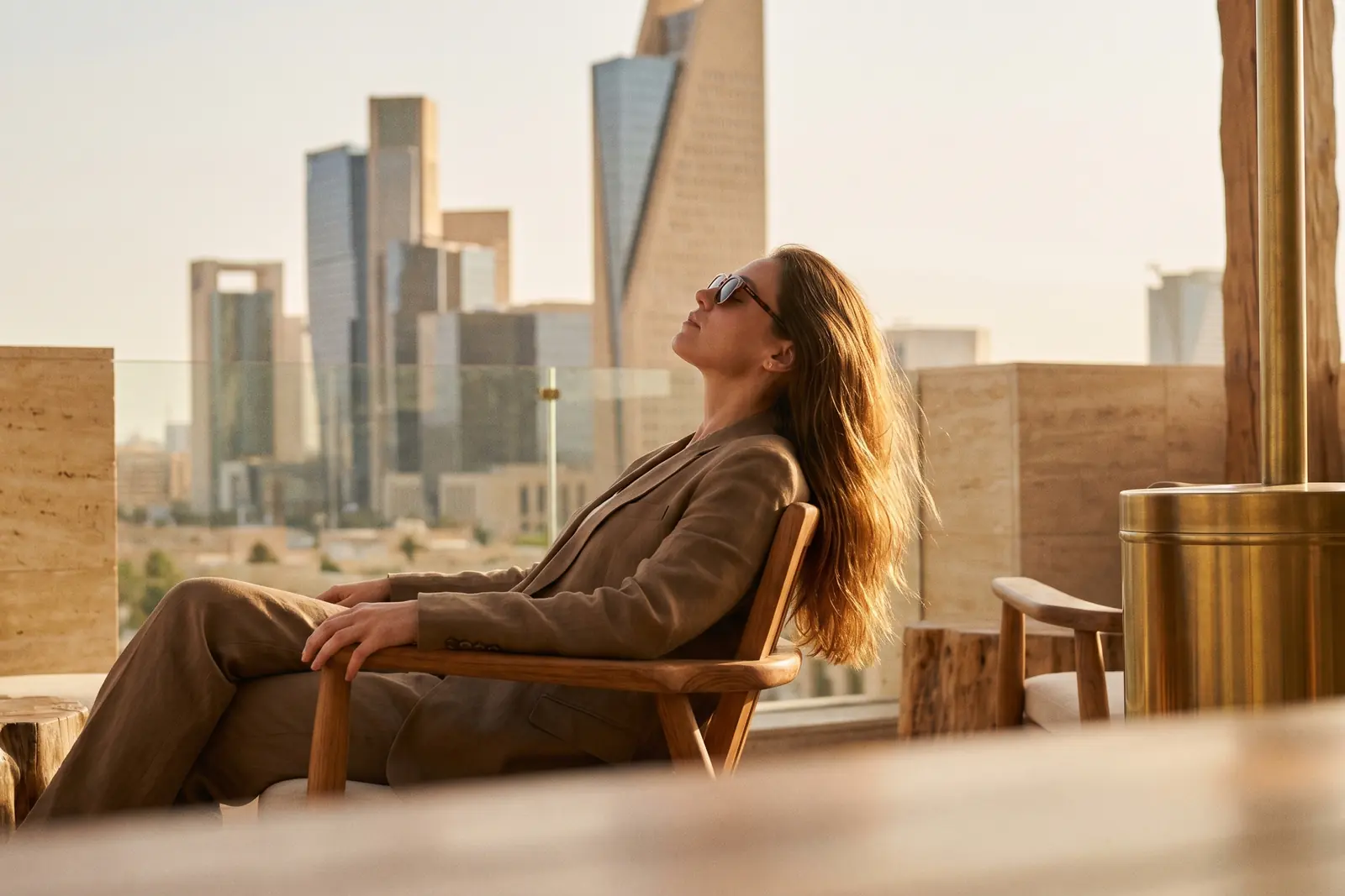 Guest lounging on a terrace facing the skyline