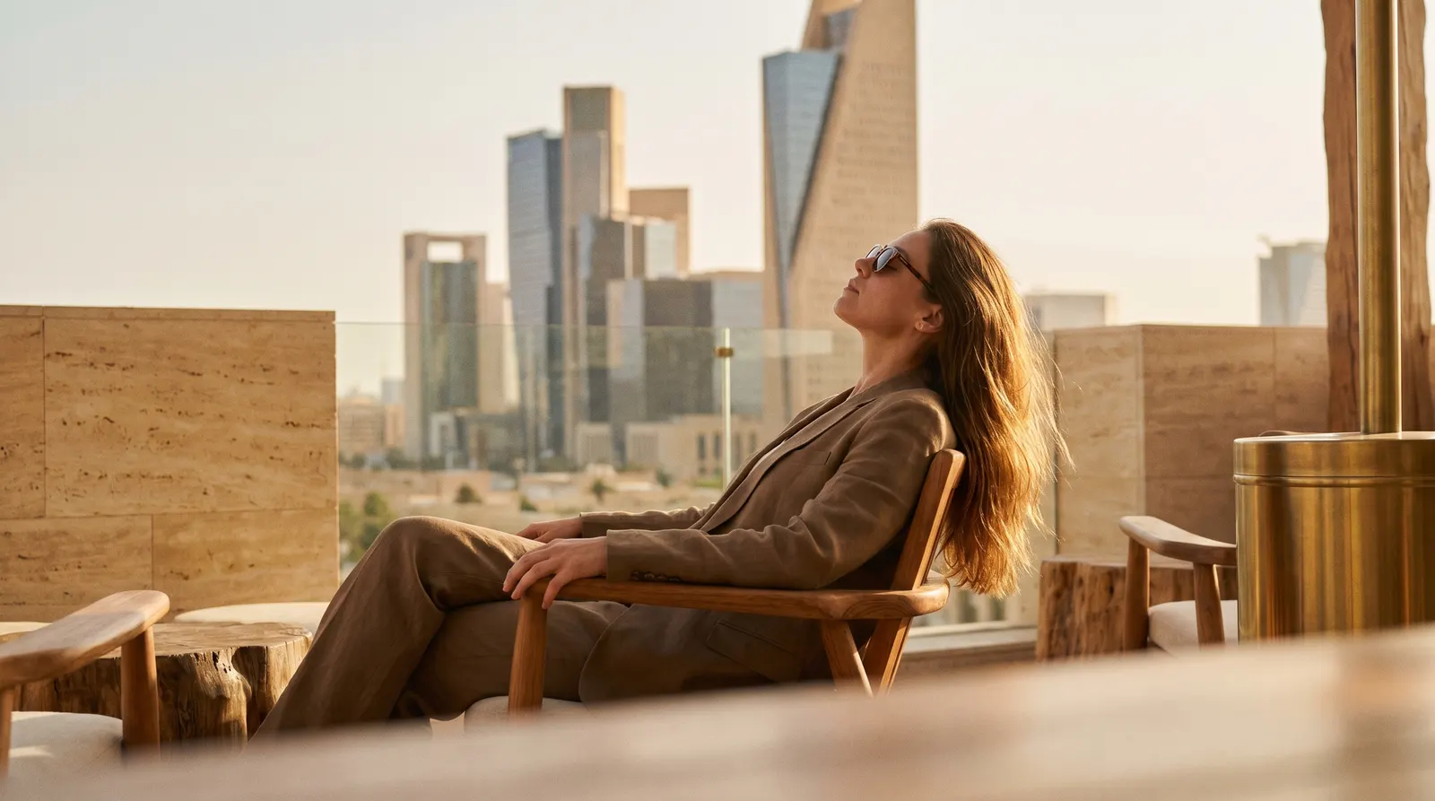 Guest lounging on a terrace facing the skyline