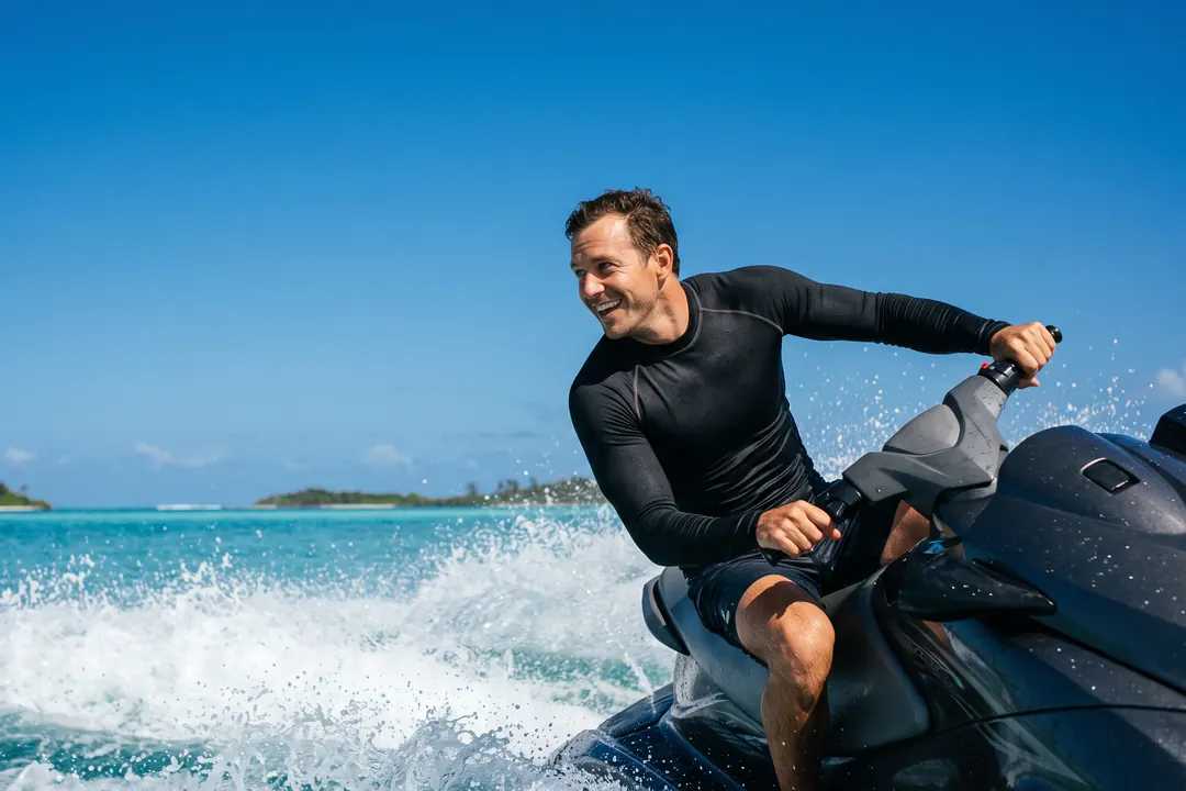 Man riding a jet ski across turquoise water